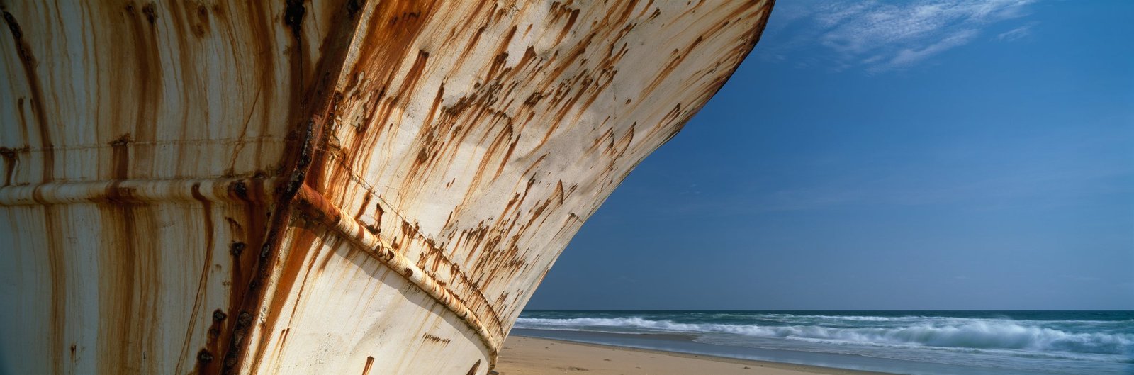 The rust streaked bow of the Vanessa Seafood against a blue sky and sea in Angola