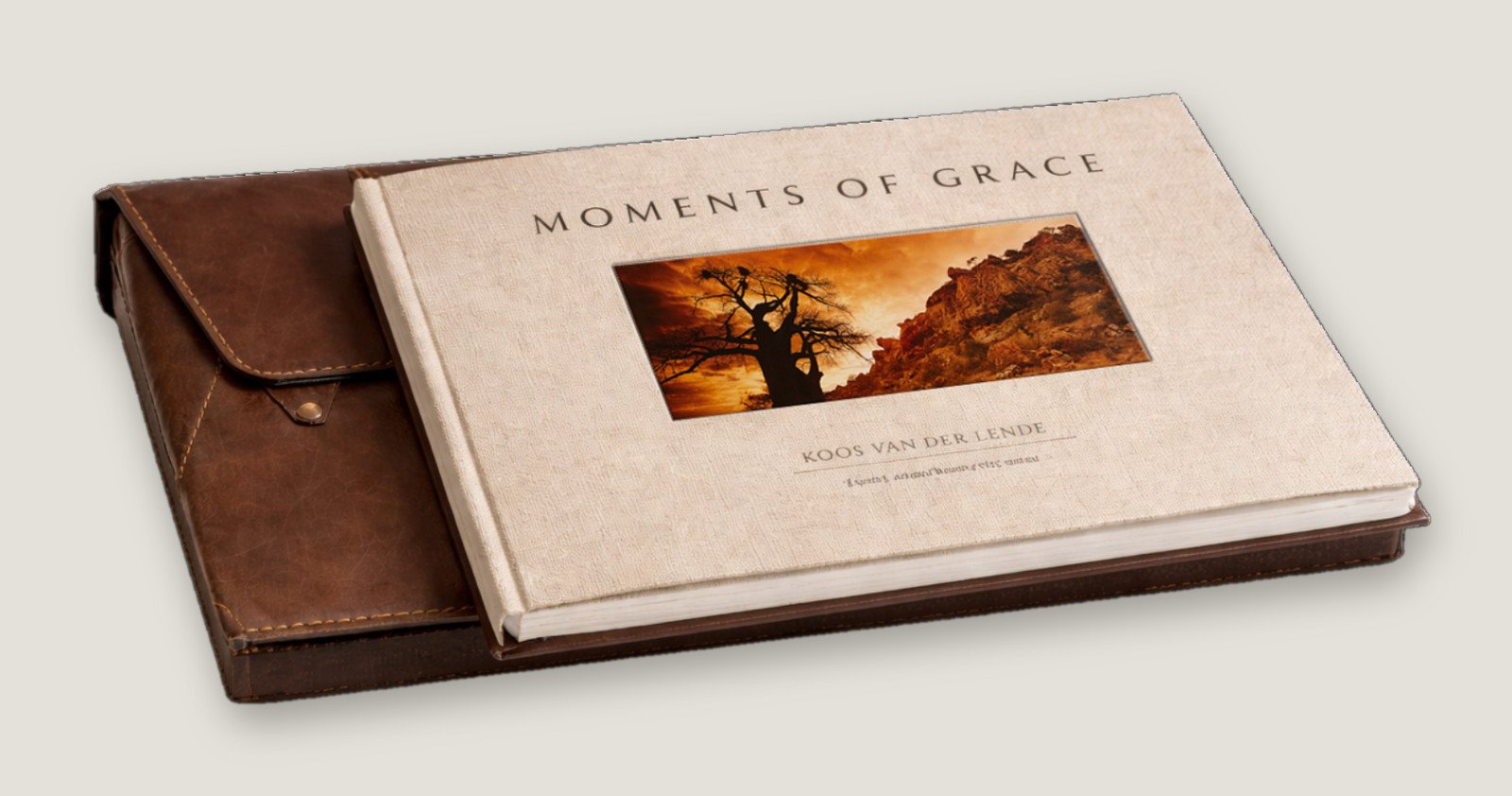 Moments of Grace with its linen cover beside the handmade leather pouch
