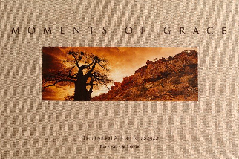 The linen cover of Moments of Grace with the African Sunrise baobab