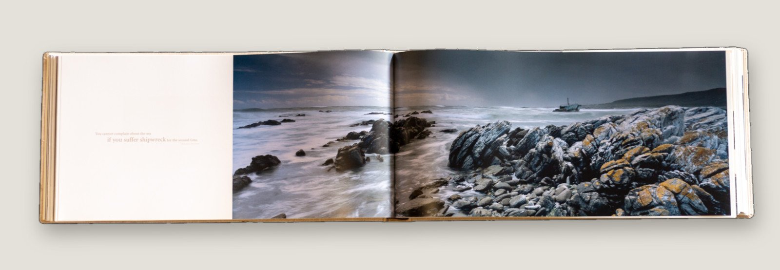 Moments of Grace open at a coastal panorama of rocks and surf